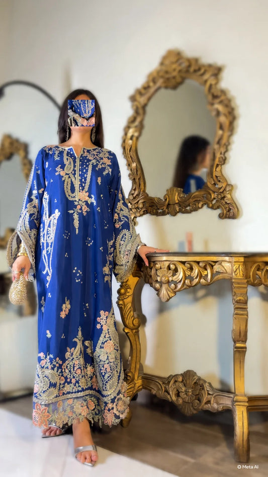 Detail shot of embroidered cuff and gold bangles on royal blue silk kaftan suit