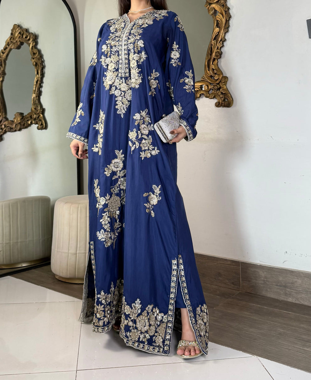 Full-length front shot of a regal sapphire royal blue stitched silk maxi dress featuring heavy traditional hand-embellishment on the borders.