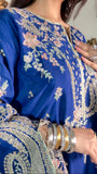 Round slit neckline of blue embroidered kaftan suit with mint piping and gold thread work