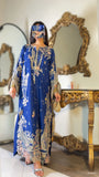 Side view of blue embroidered kaftan suit showing bell sleeve embroidery detail