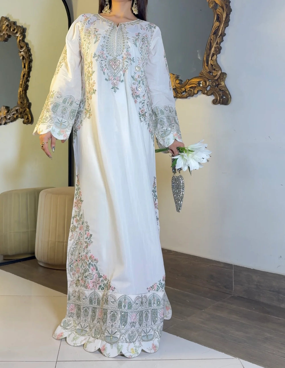 Close-up of ivory kaftan bodice with pastel floral embroidery and sequin detailing