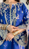 Close-up of royal blue silk kaftan suit with gold and silver zari embroidery and layered bangles