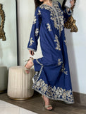 Editorial pose displaying the high side slit detailing, metallic embroidery border, and tailored matching trousers of a royal blue luxury pret outfit.
