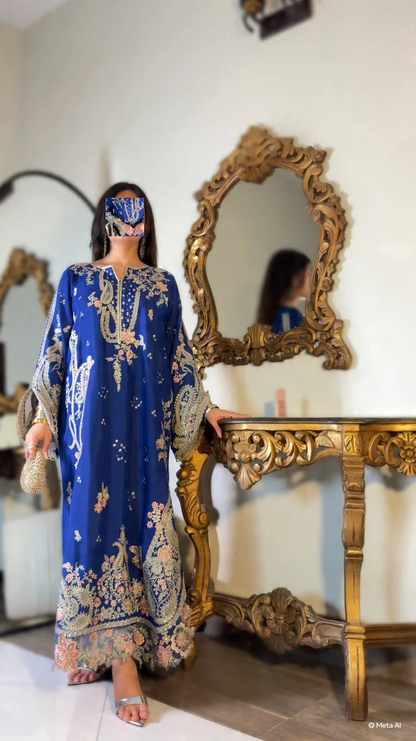 Model styled with dupatta draped over head, wearing royal blue embroidered kaftan suit