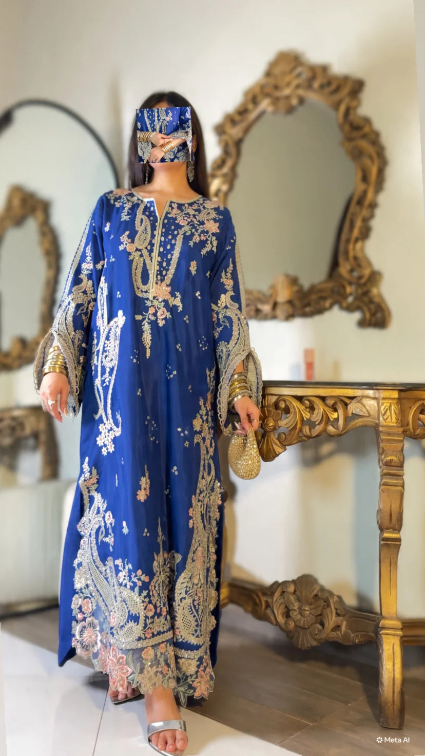 Side view of blue embroidered kaftan suit showing bell sleeve embroidery detail