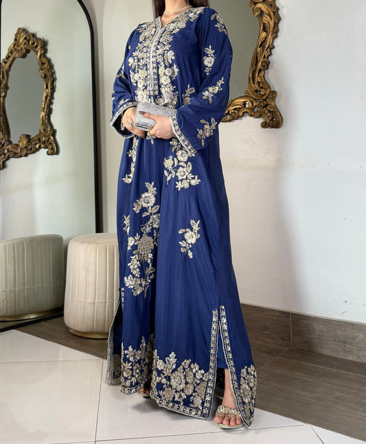 Three-quarter view highlighting the intricate craftsmanship, structural lines, and heavy floral motifs of a royal blue festive luxury pret ensemble.