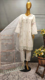 Mannequin wearing a cream embroidered kurta with a sheer dupatta in a room setting.