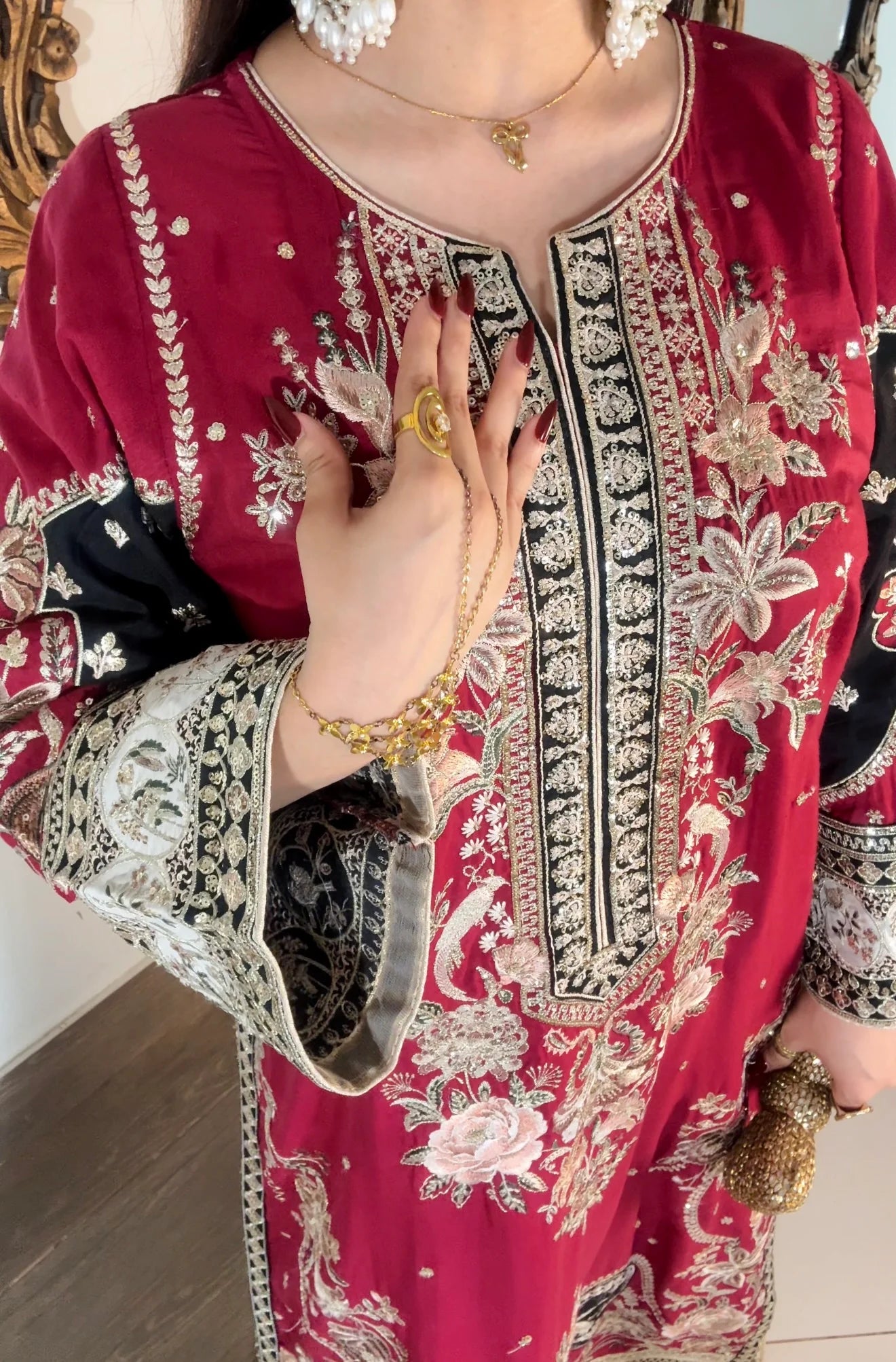 Close-up of gold sequin neckline embroidery on maroon festive kaftan